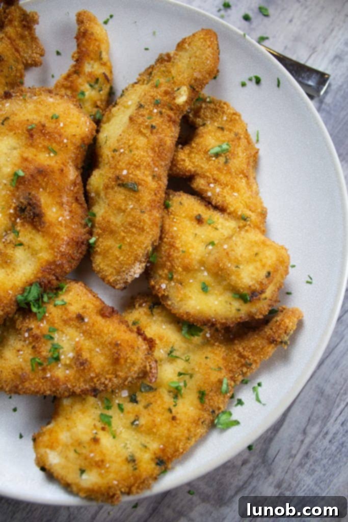 Essential Italian Dishes to Master at Home 2 Crispy Italian Chicken Cutlets, golden brown and perfectly breaded