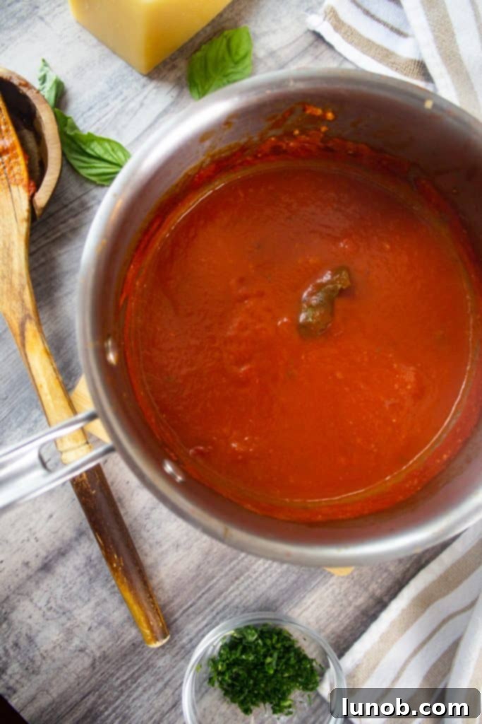 Essential Italian Dishes to Master at Home 4 Sunday Sauce in a Pot with a wooden spoon, fresh parsley, basil and parmesan cheese, simmering gently