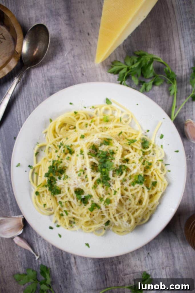Essential Italian Dishes to Master at Home 5 Spaghetti with Garlic and Oil (Aglio e Olio) with fresh parsley and parmesan in frame