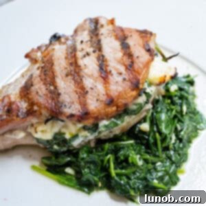 Smoky Grilled Stuffed Pork Chops 11 A grilled pork chop stuffed with feta and sauteed spinach and garlic served on more sauteed spinach.