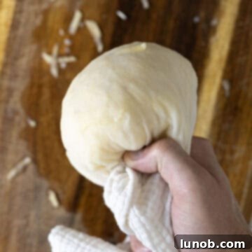 Drying grated potatoes completely using a cheesecloth.