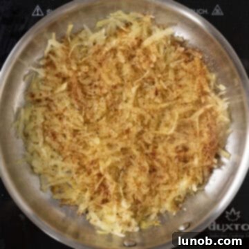 Layer of hash browns, seasoned with paprika, garlic powder, salt, and pepper.