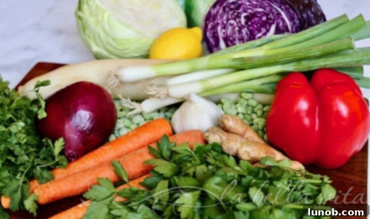 Close-up of Asian Chopped Salad ingredients, showing shredded carrots, chopped cabbage, and green onions mixed together.