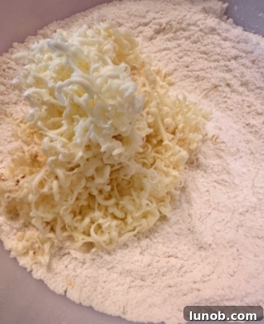 Cold butter cubes added to dry scone ingredients.