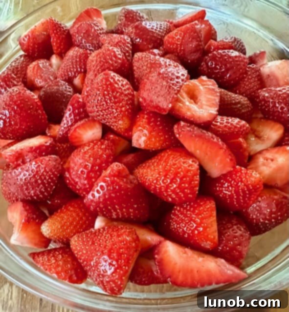 Fresh strawberries being cleaned and destemmed.