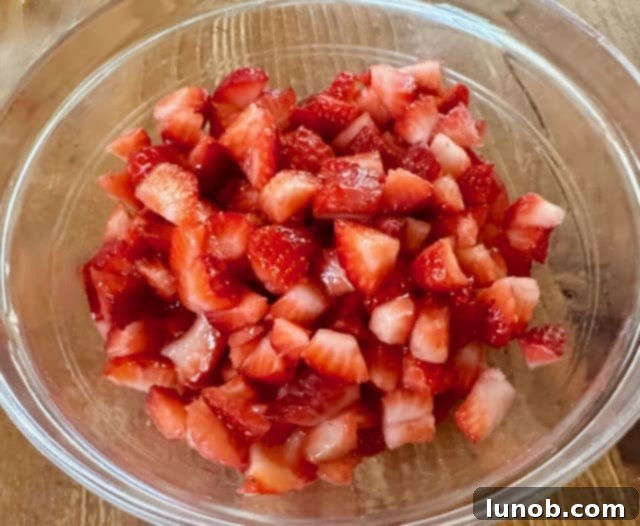 Diced fresh strawberries in a bowl.