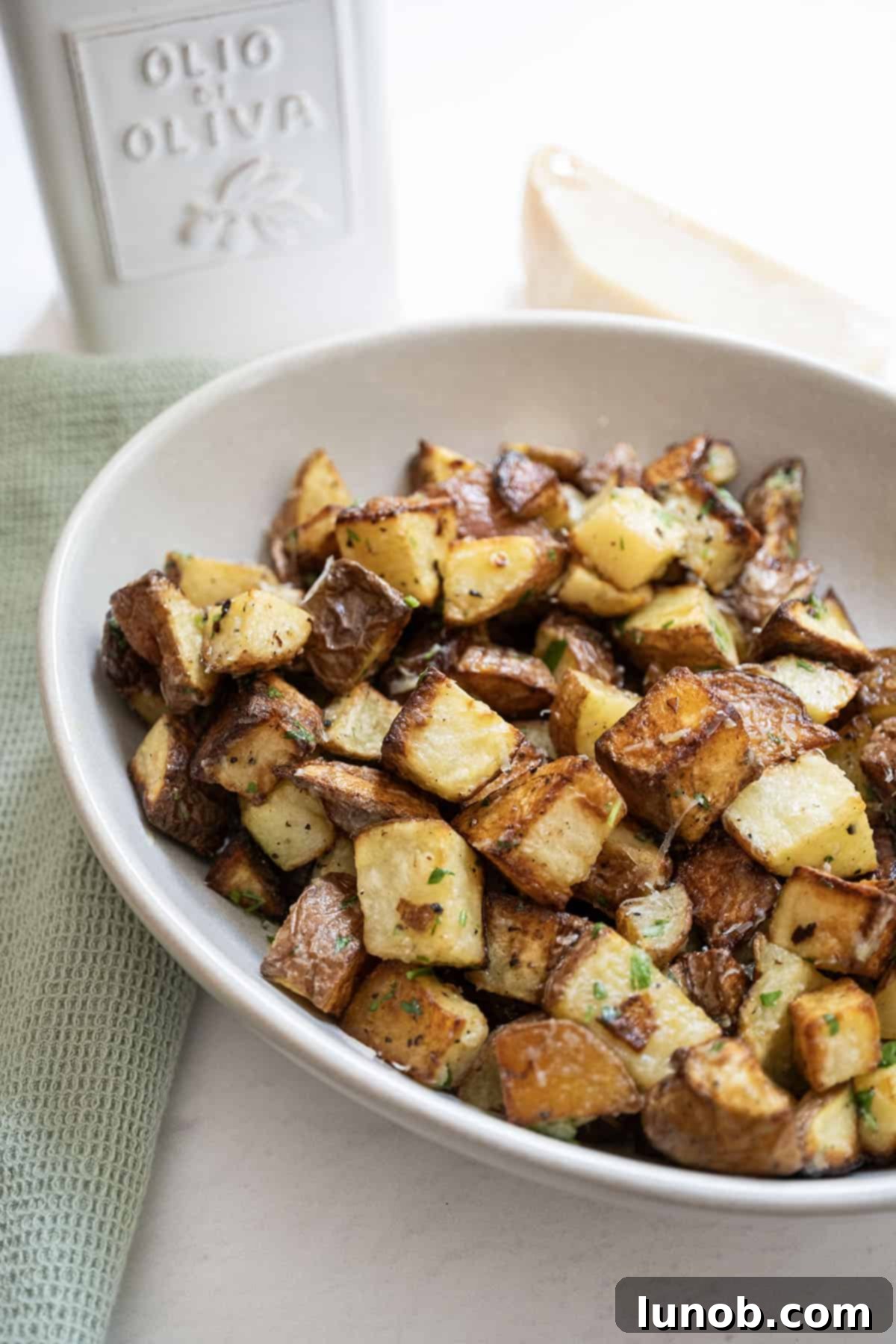 Ultimate Crispy Garlic Parmesan Potatoes 2 Crispy potatoes in a bowl, perfectly golden brown and seasoned.