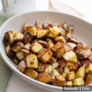 Ultimate Crispy Garlic Parmesan Potatoes 13 garlic parmesan potatoes in a bowl.