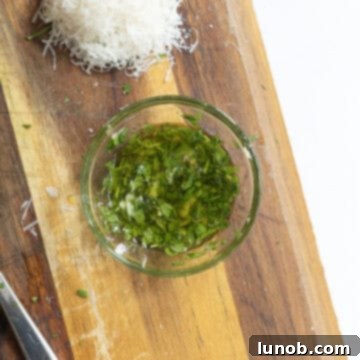 Ultimate Crispy Garlic Parmesan Potatoes 9 Roasted garlic paste, fresh parsley, and olive oil in a small bowl, ready to be mixed.
