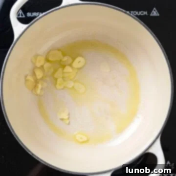 Garlic sauteing in a dutch oven. 