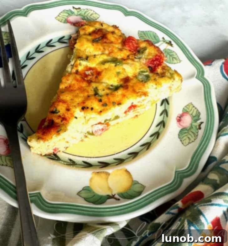 A beautifully golden-brown cheesy Italian frittata with visible bell peppers and herbs, ready to be served.