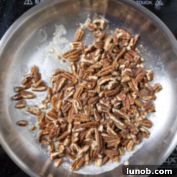 Toasting pecans in a saucepan.