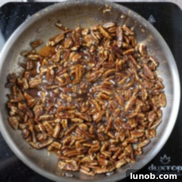 Simmering pecans in sauce.