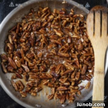 Caramelizing sugar to pecans in the pan.