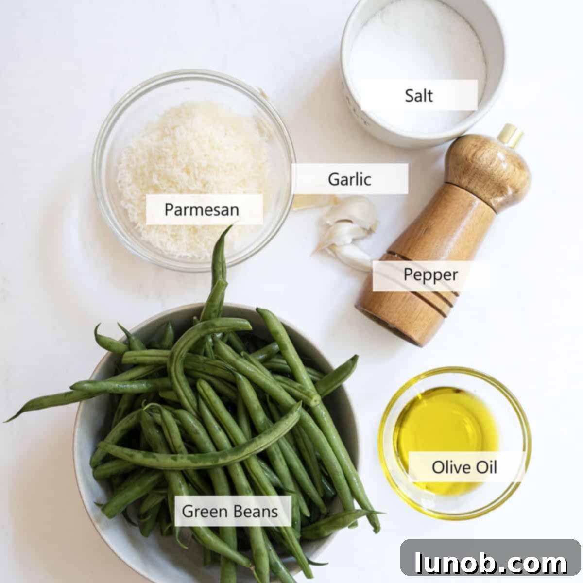 Garlic Parmesan Green Beans: A Timeless Classic 3 Fresh ingredients for green bean recipe, including green beans, garlic, olive oil, and parmesan.
