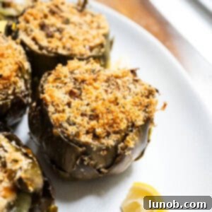 Stuffed artichokes on a plate with lemon, ready to serve.