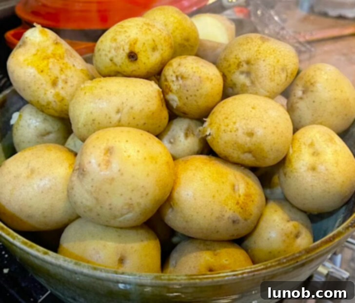 Drying boiled potatoes with a dish towel.