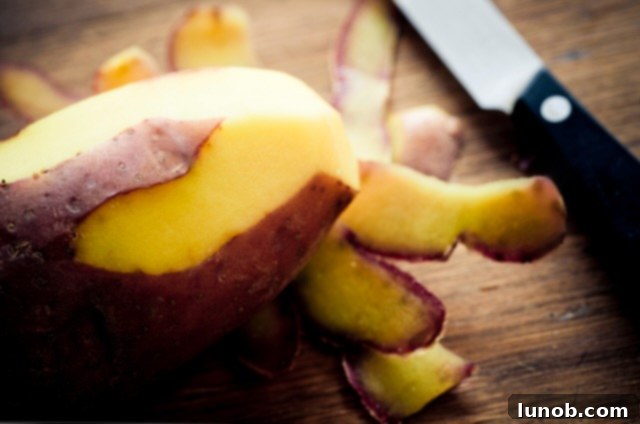 Warm potatoes being peeled for gnocchi.