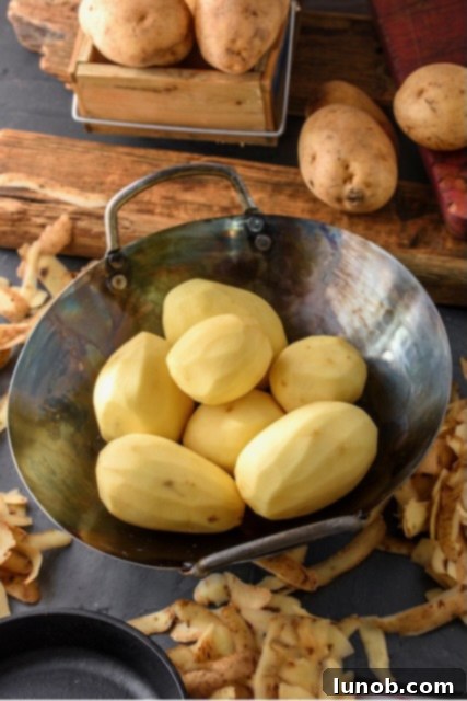 Close-up of potato peeling process.