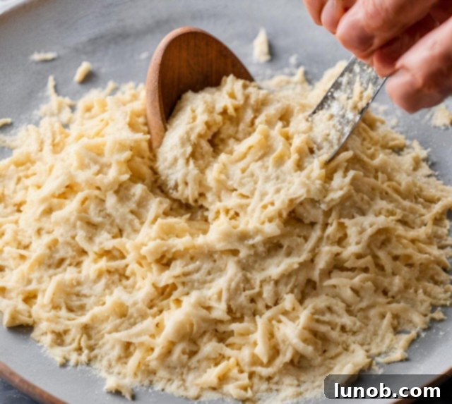 Adding flour and nutmeg to riced potatoes.