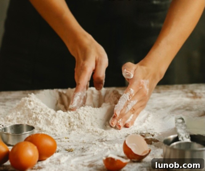 Forming a well in potato and flour mixture.