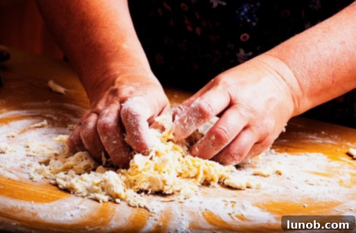 Finishing mixing gnocchi dough by hand.
