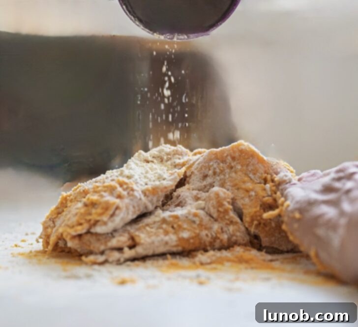 Adjusting gnocchi dough consistency with flour.