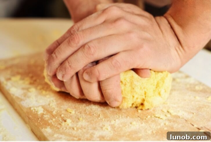 Hand kneading gnocchi dough technique.