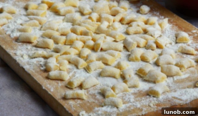 Cut gnocchi dough pieces on a floured board.