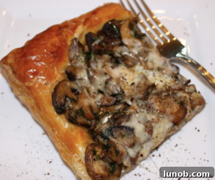 A slice of mushroom tart with Asiago and Parmesan cheese.