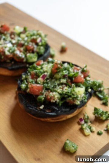 Toasted burger bun topped generously with fresh, vibrant tabbouleh.