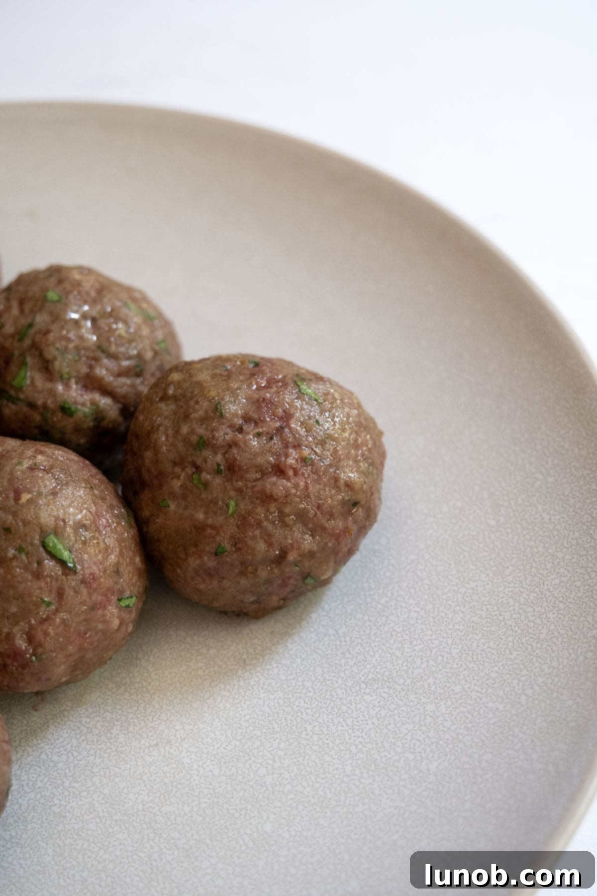 Pile of baked meatballs showing softer texture.