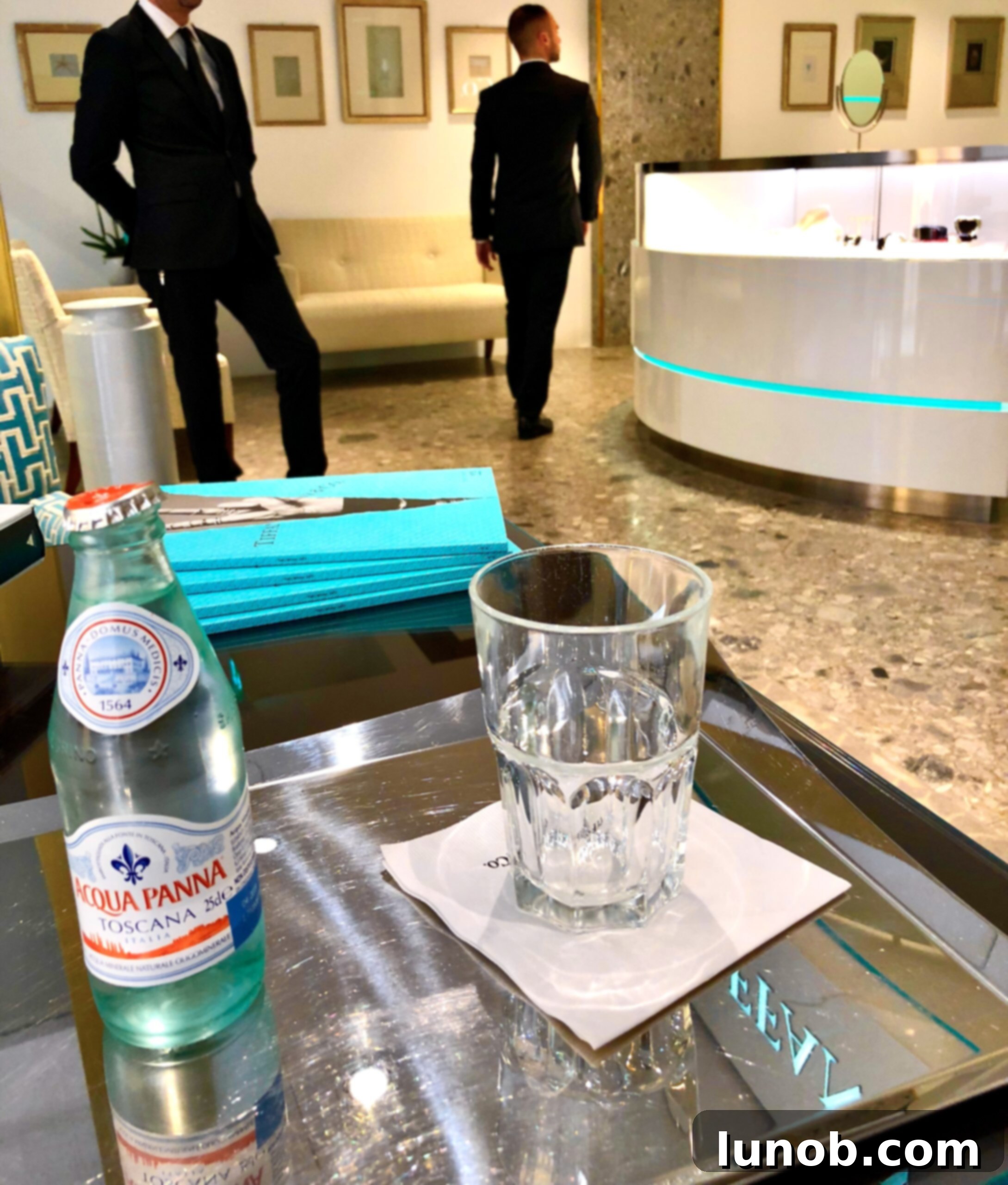 Italian water bottle mirroring Tiffany blue, with reflection of signage