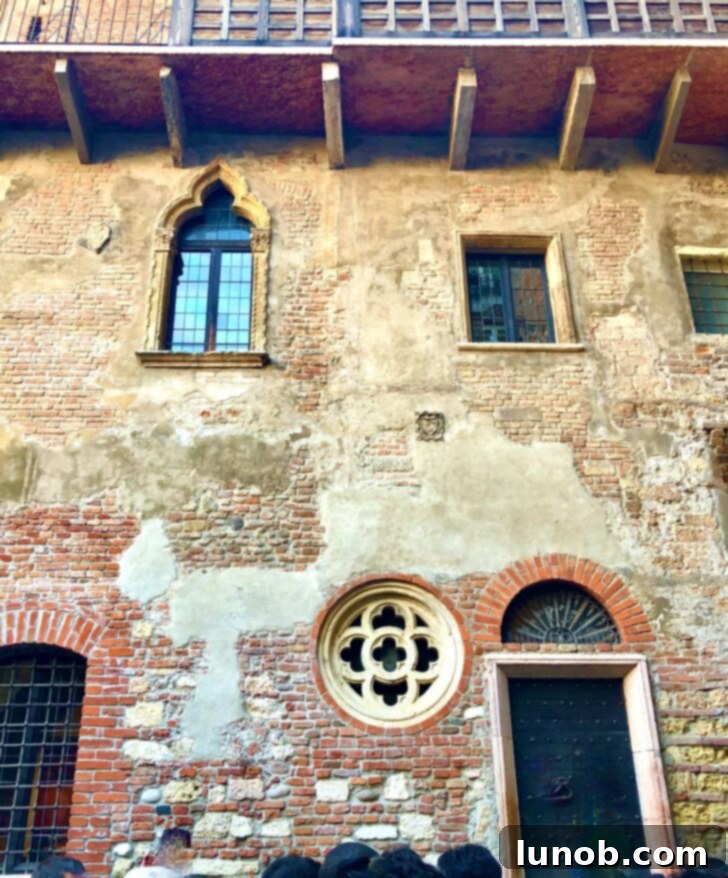Wall covered in pasted love notes and wishes near Juliet's House