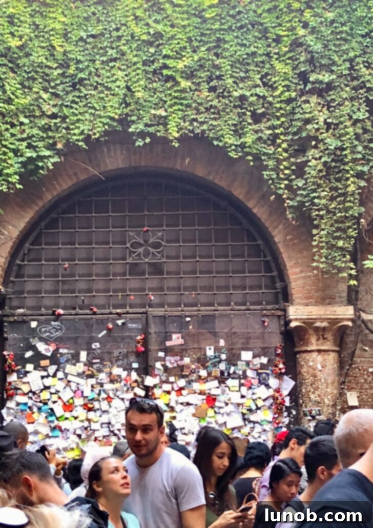 Juliet's famous balcony in Verona, seen from the extremely crowded courtyard
