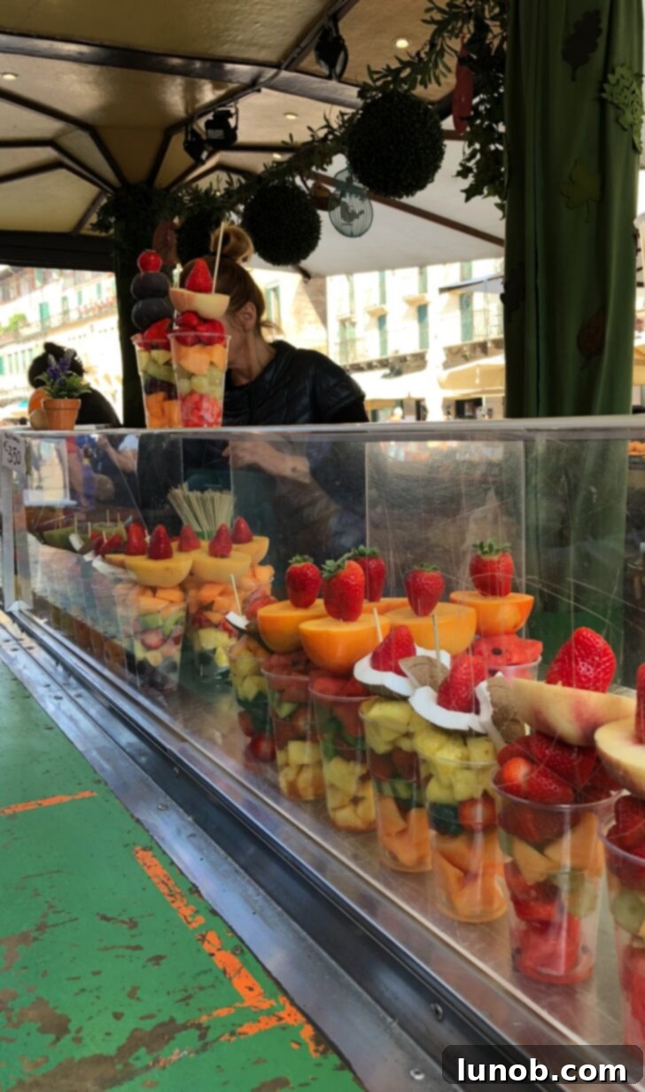 Vendor selling fresh fruit parfaits at the green market in Piazza delle Erbe, Verona