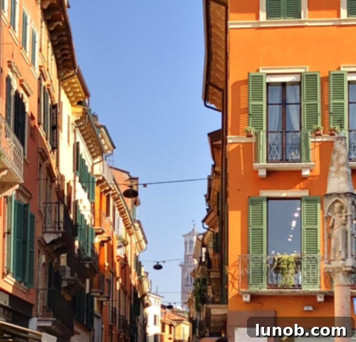 Close-up of a Verona building facade with small balconies and shuttered windows