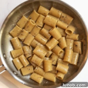 Pasta Alla Gricia: Rome's Simple Perfection 10 The sauce has fully emulsified, appearing smooth and silky in the pan, and is removed from heat.