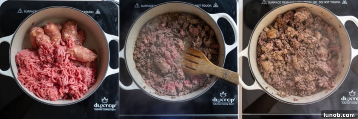 Ground beef and sweet Italian sausage browning in a large Dutch oven on the stovetop.