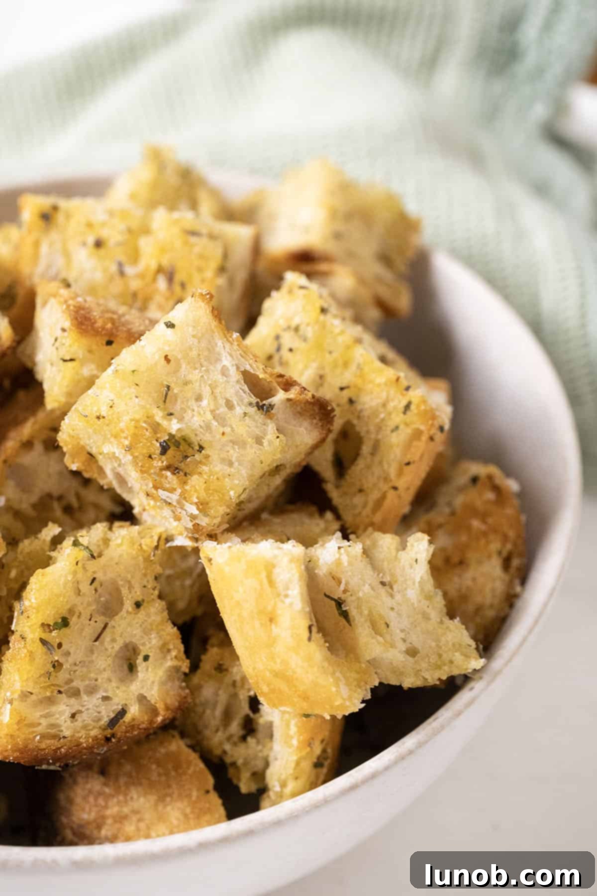Crispy Homemade Parmesan Croutons 2 Parmesan seasoned croutons in a bowl.