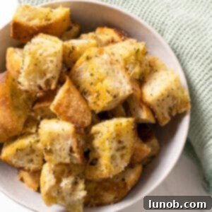 Crispy Homemade Parmesan Croutons 10 Parmesan seasoned croutons in a bowl.
