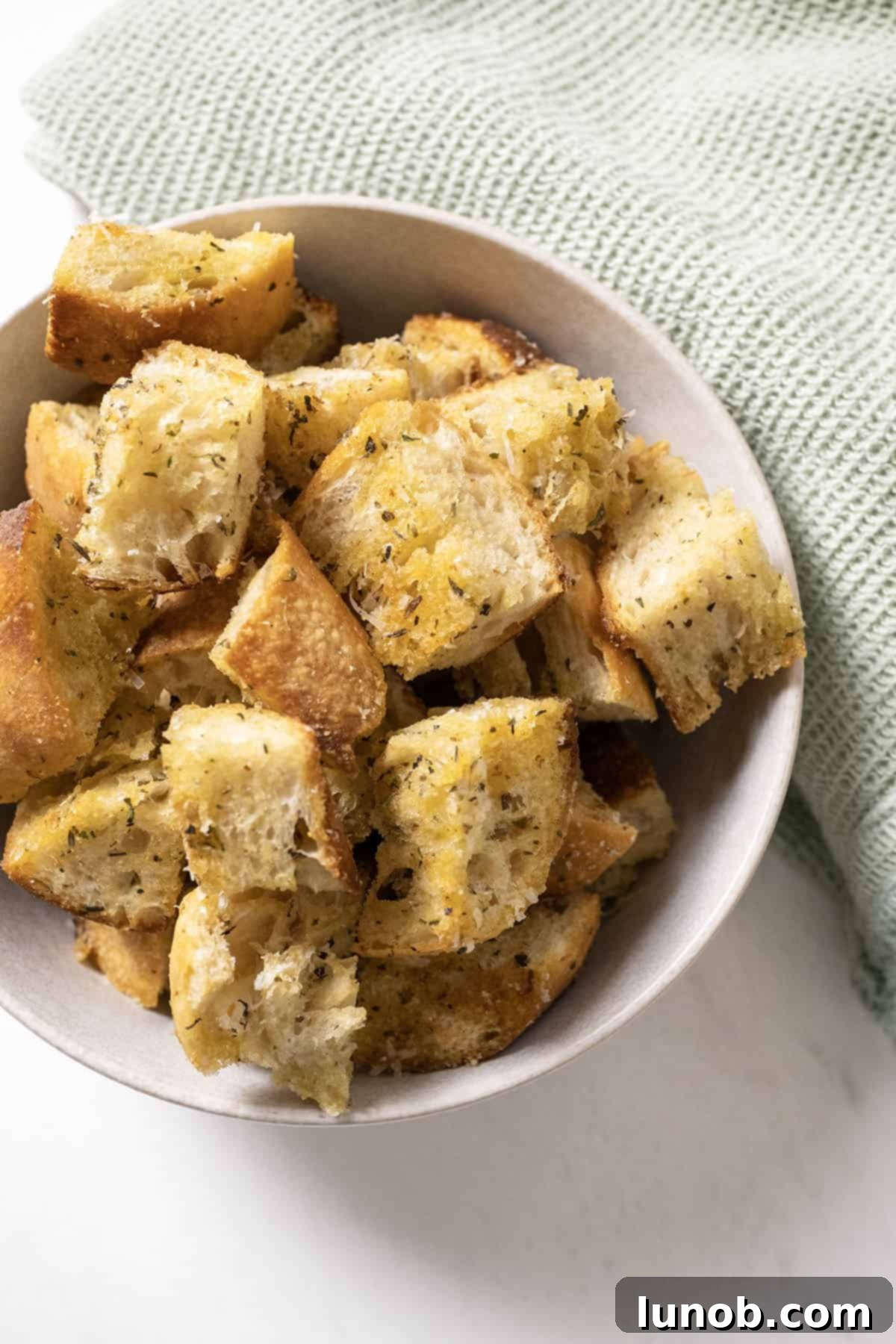Crispy Homemade Parmesan Croutons 9 Parmesan seasoned croutons in a bowl.