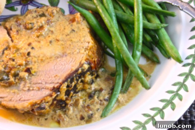 Rich, golden, and slightly curdled milk sauce, a signature component of traditional Italian Pork Loin Braised in Milk, perfect for soaking up with artisanal bread.