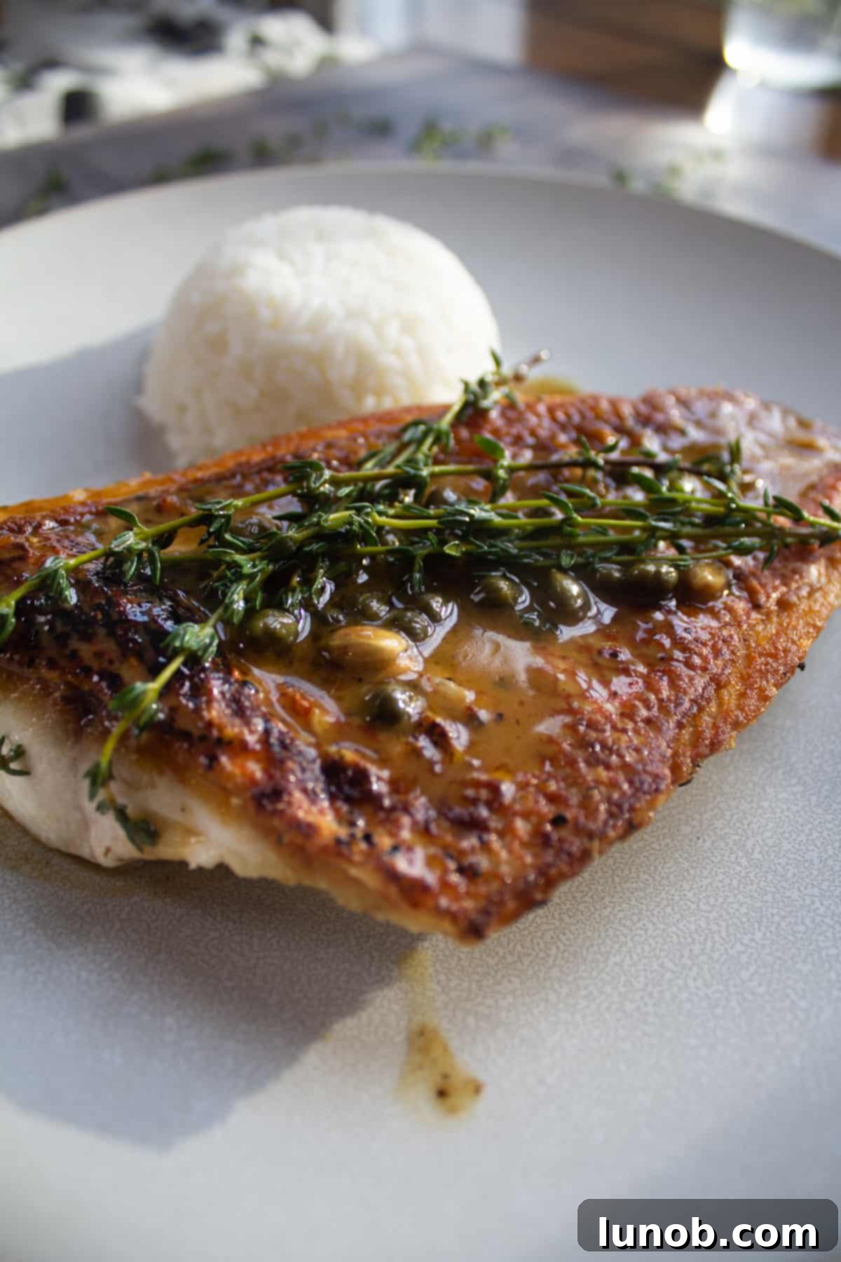 snapper topped with thyme and capers with rice pilaf