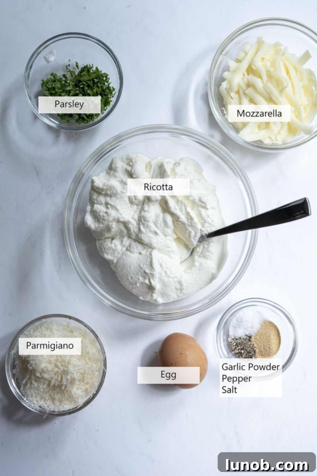 Creamy Ricotta Dreams 3 Fresh ingredients laid out for a creamy ricotta mixture, including cheese, eggs, and herbs.