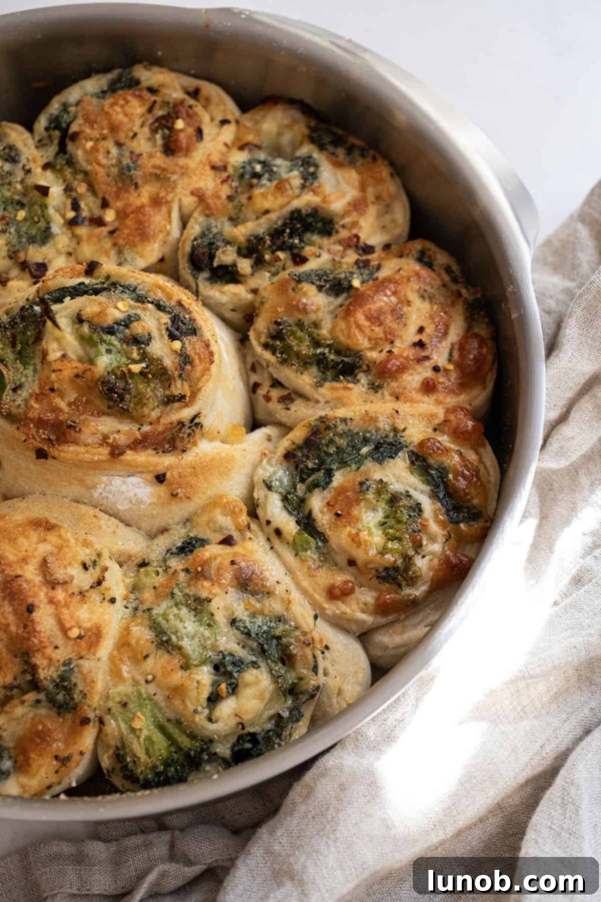 Veggie pinwheels baked to golden perfection in a cake pan, ready to be served.