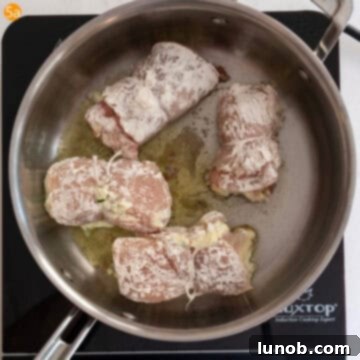 Frying chicken rollatini in a large saucepan until golden brown.