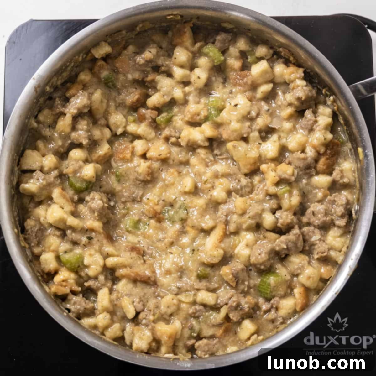 Ultimate Italian Sausage Stuffed Mushrooms 8 Fully combined sausage and bread stuffing mixture in a saucepan, ready for stuffing.