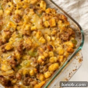 Savory Italian Sausage Thanksgiving Stuffing 13 Italian sausage stuffing baked in a glass baking pan, golden brown and ready for a holiday feast.
