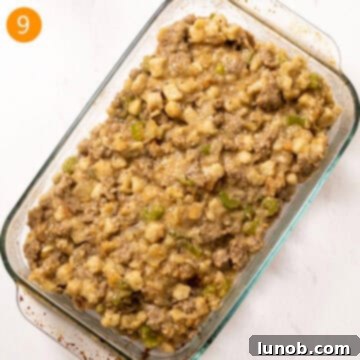 Savory Italian Sausage Thanksgiving Stuffing 10 Prepared Italian sausage stuffing spread evenly in a glass 9x13 baking pan, ready for the oven.